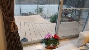 狭いリビングが広く感じる人工木ウッドデッキ。曲線を取り入れ景観に優しさを